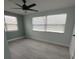 Spacious bedroom with ceiling fan and light gray vinyl flooring at 2048 Tumbleweed Dr, Holiday, FL 34690