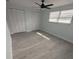 Bedroom with ceiling fan, vinyl flooring and double door closet at 2048 Tumbleweed Dr, Holiday, FL 34690