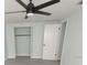 Bedroom with ceiling fan, closet, and laminate flooring at 2048 Tumbleweed Dr, Holiday, FL 34690
