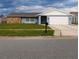 Ranch style home with stone accents and a two-car garage at 2048 Tumbleweed Dr, Holiday, FL 34690