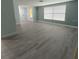 Bright living room with light gray vinyl flooring and pale walls at 2048 Tumbleweed Dr, Holiday, FL 34690