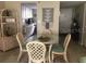 Bright dining area with glass table and four chairs at 2060 Marilyn St # 103, Clearwater, FL 33765