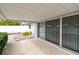 Covered patio, sliding glass doors, and access to backyard at 2124 16Th Sw Ave, Largo, FL 33770
