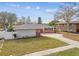 Brick ranch house with a well-maintained lawn at 2124 16Th Sw Ave, Largo, FL 33770