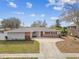 Front view of a charming ranch house with a driveway at 2124 16Th Sw Ave, Largo, FL 33770