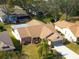 Aerial view of a single-story house with a brown roof and landscaped lawn at 2249 Grandfather Mtn, Spring Hill, FL 34606