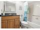 Bathroom with a tub, toilet and wood vanity at 2249 Grandfather Mtn, Spring Hill, FL 34606