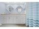 Clean bathroom with double vanity, light blue walls, and a shower at 2249 Grandfather Mtn, Spring Hill, FL 34606