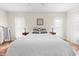 Bright bedroom with a queen-size bed, hardwood floors, and neutral decor at 2249 Grandfather Mtn, Spring Hill, FL 34606