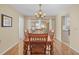 Dining room with hardwood floors, chandelier, and access to kitchen at 2249 Grandfather Mtn, Spring Hill, FL 34606
