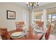 Bright dining room with wooden table, chairs, and view to backyard at 2249 Grandfather Mtn, Spring Hill, FL 34606