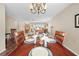 Dining room features a wood table and seating for four, overlooking living room at 2249 Grandfather Mtn, Spring Hill, FL 34606