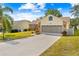 House exterior showcasing a driveway and screened garage at 2249 Grandfather Mtn, Spring Hill, FL 34606