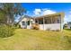 Well-maintained house with a screened porch and a grassy backyard at 2249 Grandfather Mtn, Spring Hill, FL 34606
