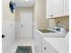 Convenient laundry room with washer, dryer, and storage cabinets at 2249 Grandfather Mtn, Spring Hill, FL 34606