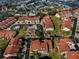 Overhead aerial of condo community with red roofs, pool, and waterway views at 2353 Hanover Dr, Dunedin, FL 34698