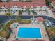 Aerial view of townhomes with a community pool and tropical landscaping at 2353 Hanover Dr, Dunedin, FL 34698
