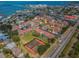Wide aerial shot of condo community with red roofs, a community pool, and Gulf access at 2353 Hanover Dr, Dunedin, FL 34698