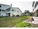 View of the condo backyard with patio area, landscaping, and grassy space at 2353 Hanover Dr, Dunedin, FL 34698