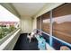 A cozy, screened balcony with comfortable seating and a view of the neighborhood at 2353 Hanover Dr, Dunedin, FL 34698