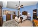Primary bedroom suite featuring blue walls, a ceiling fan, and classic furnishings at 2353 Hanover Dr, Dunedin, FL 34698