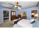Comfortable primary bedroom featuring blue walls, ample lighting, and a spacious closet at 2353 Hanover Dr, Dunedin, FL 34698