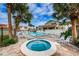 Community pool and hot tub surrounded by tropical landscaping at 2353 Hanover Dr, Dunedin, FL 34698