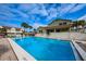 Large community pool with lounge chairs and verdant landscaping at 2353 Hanover Dr, Dunedin, FL 34698