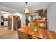 View of a bright dining room featuring stylish wooden furniture, laminate flooring, and stainless steel appliances at 2353 Hanover Dr, Dunedin, FL 34698