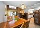 View of a bright dining room and kitchen with stylish wooden furniture and laminate flooring at 2353 Hanover Dr, Dunedin, FL 34698
