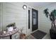 View of a cozy outdoor entrance with well-maintained light-colored siding and decorative accents at 2353 Hanover Dr, Dunedin, FL 34698