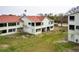 Two-story townhouse with a red roof and green grass lawn at 2353 Hanover Dr, Dunedin, FL 34698