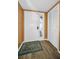 View of a bright foyer featuring laminate floors, a closet, and a decorated front door at 2353 Hanover Dr, Dunedin, FL 34698