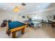 Spacious game room featuring a pool table, ping pong table, and tile floors at 2353 Hanover Dr, Dunedin, FL 34698