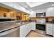 Modern kitchen features stainless steel appliances, white cabinets, and ample counter space, perfect for cooking and entertaining at 2353 Hanover Dr, Dunedin, FL 34698