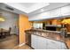 Kitchen view into dining and living areas, boasting a stainless steel dishwasher and ample counter space at 2353 Hanover Dr, Dunedin, FL 34698