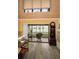 Bright living room features a cozy fireplace, hard wood floors, and balcony view at 2353 Hanover Dr, Dunedin, FL 34698