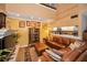 Comfortable living room with sofa, TV, shelves with decor, and partial kitchen view at 2353 Hanover Dr, Dunedin, FL 34698