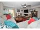 Inviting living room features a comfortable sectional sofa, stylish decor, and sliding doors to the patio at 2353 Hanover Dr, Dunedin, FL 34698