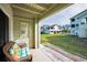 Cozy covered patio overlooks the lush community lawn, perfect for quiet enjoyment at 2353 Hanover Dr, Dunedin, FL 34698