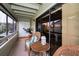 This cozy screened porch has wicker chairs, a small table, and an outdoor view at 2353 Hanover Dr, Dunedin, FL 34698