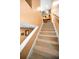 Carpeted staircase leading to the upper level with artwork and shelving along the way at 2353 Hanover Dr, Dunedin, FL 34698