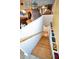 Wooden stairs leading to a lower level with model car decor along the wall at 2353 Hanover Dr, Dunedin, FL 34698