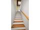 Stairway with oak steps and white risers leading up to the next level at 2353 Hanover Dr, Dunedin, FL 34698
