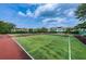 Community tennis court surrounded by green landscape and condos at 2353 Hanover Dr, Dunedin, FL 34698