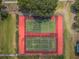 Aerial view of community tennis courts surrounded by lush green landscape at 2353 Hanover Dr, Dunedin, FL 34698