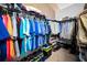 Organized walk-in closet with hanging clothes, shelving, and shoe storage at 2353 Hanover Dr, Dunedin, FL 34698