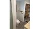 Simple bathroom with shower, toilet, and storage shelves at 283 Brennan St, Brooksville, FL 34601