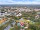 Wide aerial showcasing home, community, tennis court and pond at 291 Winchester Way, Palm Harbor, FL 34684