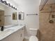 Updated bathroom with white vanity, marble countertop and tile shower at 291 Winchester Way, Palm Harbor, FL 34684